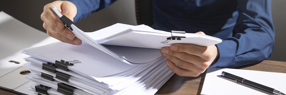 An EB-5 expert examining a stack of documents.
