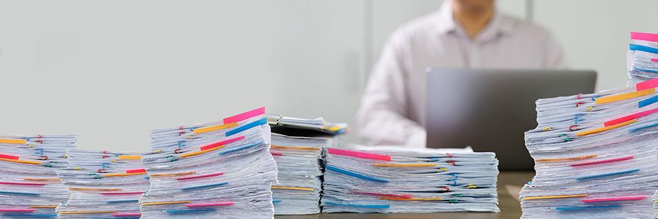 A stack of files on a table, symbolizing an EB5 visa backlog.