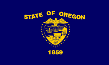 Oregon state flag with state seal in gold on a navy blue background, State of Oregon in a wavy line, and 1859 below. 