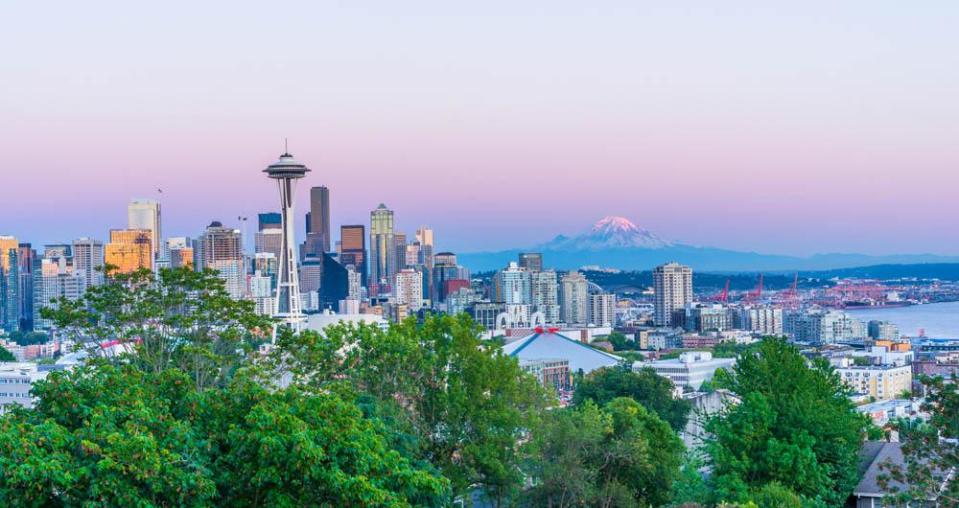 Downtown Seattle, Washington skyline highlights the Space Needle with snow-capped Mount Rainier seen in the distance.