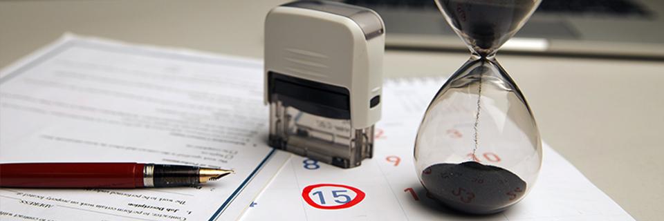 A calendar with the applicant's priority date circled, and I-485 supporting documents on a desk with a stamp and an hourglass symbolizing processing times for adjustment of status.