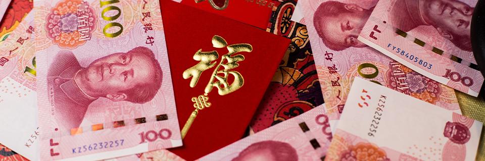 A stack of money on top of Chinese envelopes, symbolizing capital investment in exchange for permanent residency by many Chinese investors.