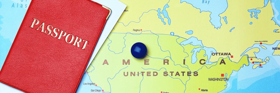 Two passport cases on top of a map of the U.S.