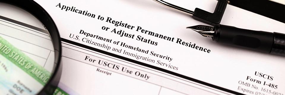 A close-up of a Form I-485, Application to Register Permanent Residence or Adjust Status.