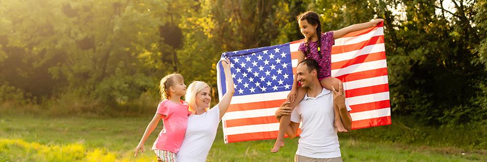 A group of foreign investors with an American flag who placed their investment funds into a new commercial enterprise through a regional center.