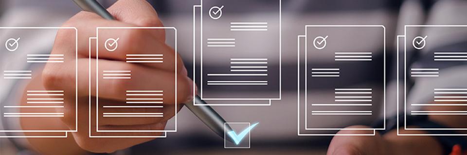 Hands ticking a digital checklist image with filing form graphics on the screen.