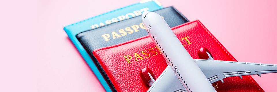 A model plane on a stack of passports.