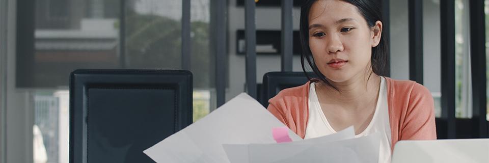 An EB-5 travel permit applicant looking at some documents.