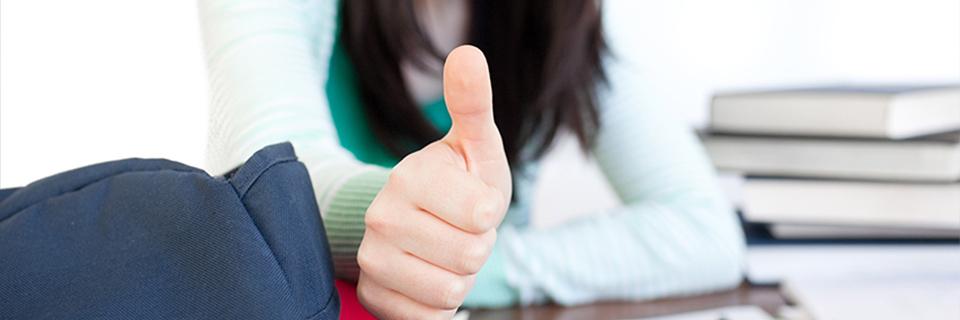 A person giving the thumbs up about their adjustment of status application.