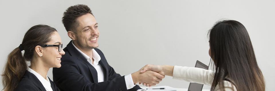 An EB-5 investor and real estate developers shaking hands.