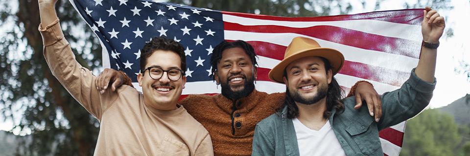 A group of Green Card applicants holding up the American flag.