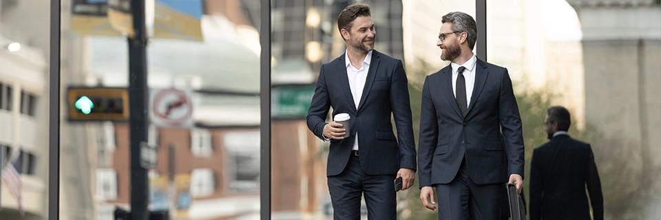 A person in a suit holding a coffee cup