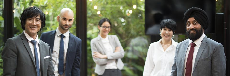 A diverse group of people standing together and smiling at the camera.