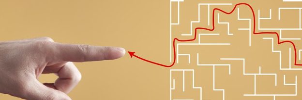 A finger pointing to a maze with a red arrow showing the way out.