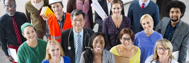 A diverse group of people smiling at the camera.
