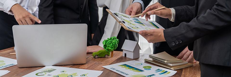 A group of people examining EB5 regional center project data and graphs.