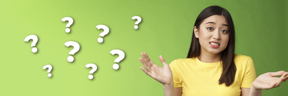 A foreign investor posing next to question mark icons.