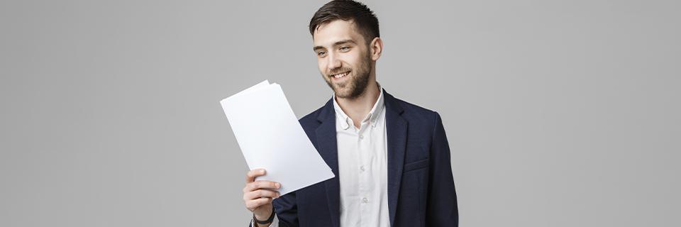An EB5 investor holding up his immigrant petition or supporting documents in his hand.