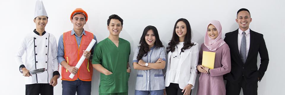 A group of employment-based visa holders from different occupations smiling at the camera.