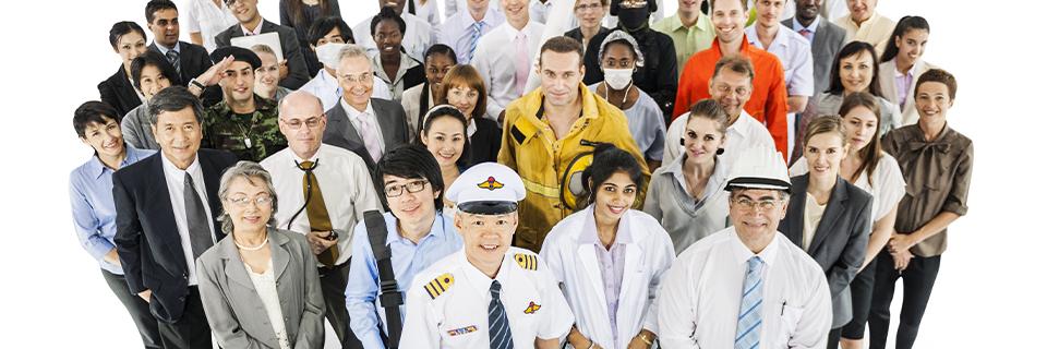 A group of foreign nationals or H1B workers in different work attire posing for the camera.
