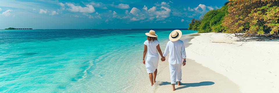 A couple of EB5 conditional green card holders walking by the sea on a vacation.