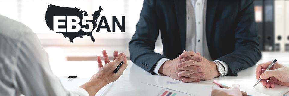 An EB5 investor having a meeting with regional center representatives or an immigration attorney under the EB5AN logo.