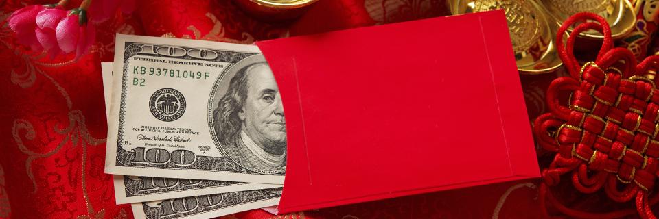 A stack of money in a red envelope, symbolizing gifts as a source of funds for Asian EB5 investors.