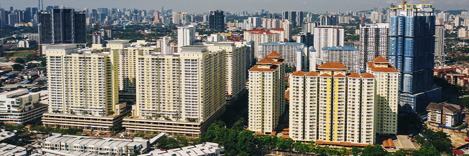 A high-angle view of a large urban real estate development with multiple residential buildings, illustrating the types of EB5 projects that benefit from using Guaranteed Maximum Price (GMP) contracts for cost control and risk management.