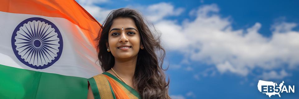 A young Indian woman standing next to the Indian flag and the EB5AN logo, highlighting her aspirations to immigrate to the US using the EB5 visa program.