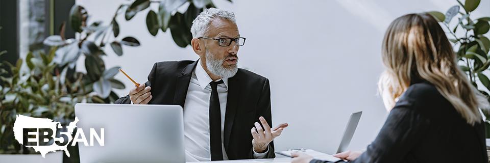 The EB5AN logo on an image symbolizing a professional consultation between an EB5 investor and an advisor, emphasizing the importance of expert guidance for EB5 success.