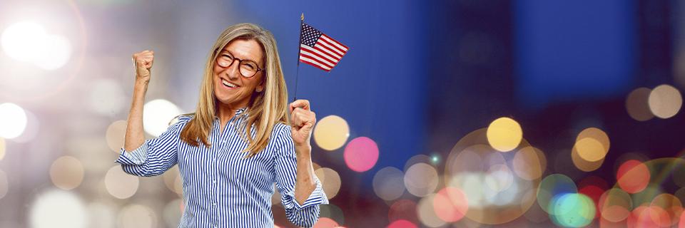 A cheerful woman holding a U.S. flag, celebrating US residency. The EB5 visa program offers foreign investors the opportunity to secure a Green Card and enjoy freedom to work and live anywhere in the United States.