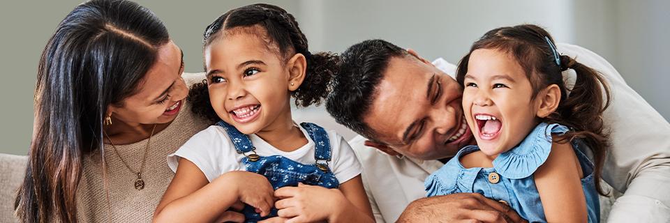 A happy family of EB5 investors laughing together, showcasing the family-friendly environment and lifestyle opportunities in the U.S.