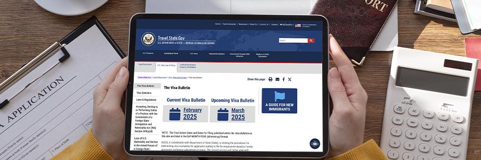  person holding a tablet displaying the U.S. Department of State's Visa Bulletin webpage, showing February and March 2025 updates. The image highlights the importance of tracking visa availability for EB5 investors.