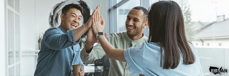 A successful group of professionals celebrating achievements, representing the benefits of the EB5 visa program for investors seeking U.S. residency through EB5AN.