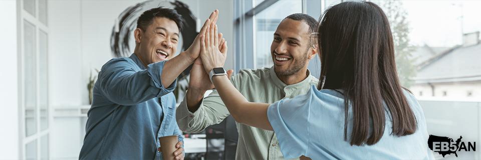 The EB5AN logo next to a team celebrating success in the EB5 process with collaborative efforts and expert guidance