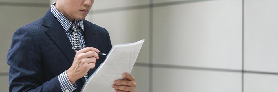 Eb5 applicant reviewing project documents and legal paperwork to determine the most suitable visa option.