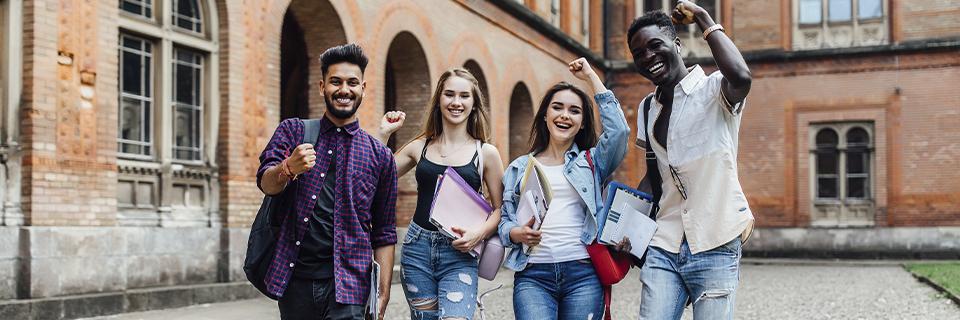 A diverse group of international students celebrating on a U.S. college campus, reflecting the EB5 path from OPT to permanent residency.