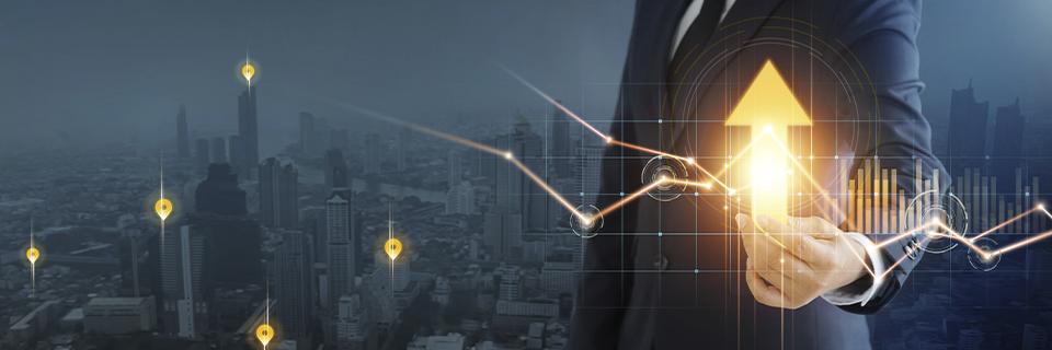 Business professional pointing at an upward growth chart, representing the economic potential of EB5 investments for entrepreneurs.