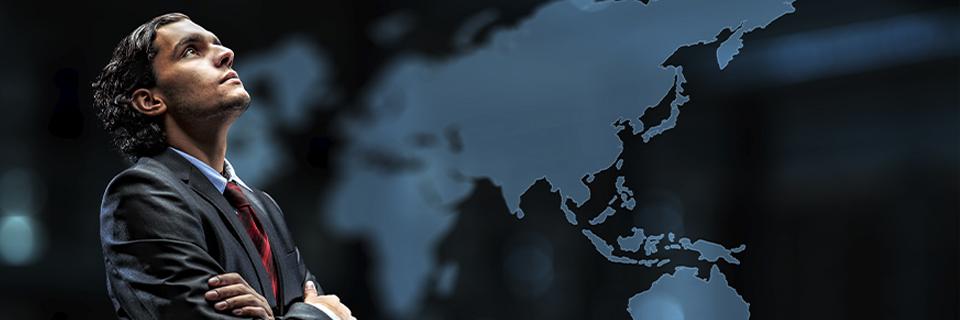 A confident investor in a suit looking upward beside a digital world map, symbolizing global EB5 migration opportunities through reserved visa categories.