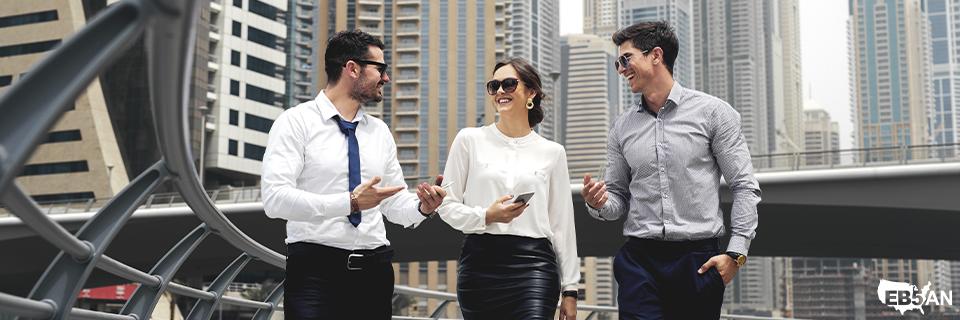 A group of international professionals walking through a modern financial district, highlighting global investor interest in EB5 set-aside visa projects offered by EB5AN.