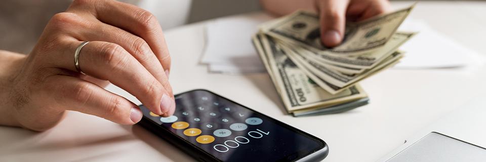 Close-up of EB5 investor calculating returns and capital risk, reflecting financial planning and project feasibility.