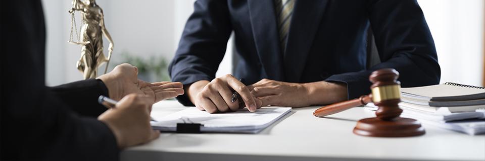 Immigration lawyer discussing documents with a client, highlighting professional guidance on EB5 immigrant intent and adjustment of status.