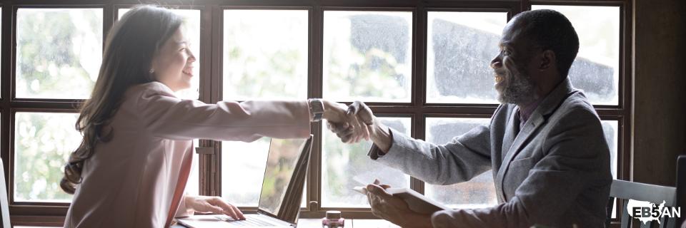 EB5AN immigration advisor and EB5 investor shaking hands in office, highlighting success in obtaining U.S. employment rights through the EB5 visa.