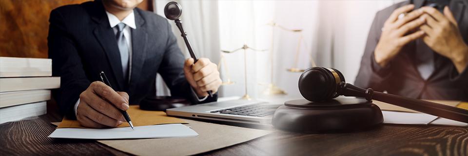 Immigration attorney or judge at desk with gavel, scales of justice, and paperwork, highlighting legal guidance in the EB5 concurrent filing process.