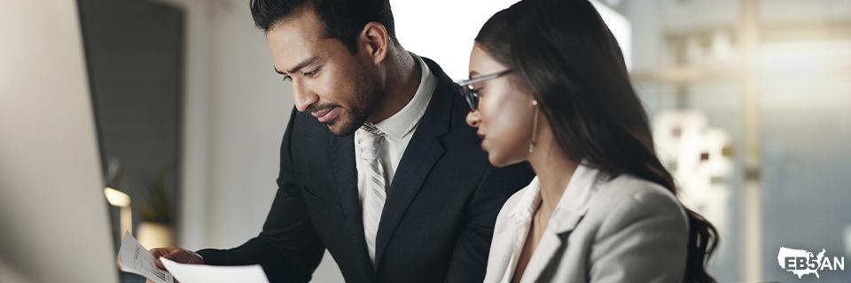 Two EB5AN team members examining paperwork together in a professional setting—highlighting expert guidance to prevent EB5 petition errors and improve approval chances.