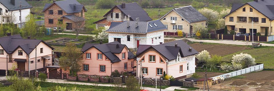 Aerial view of a suburban neighborhood with detached single-family homes, illustrating the expansion of EB5 housing projects into growing U.S. communities.