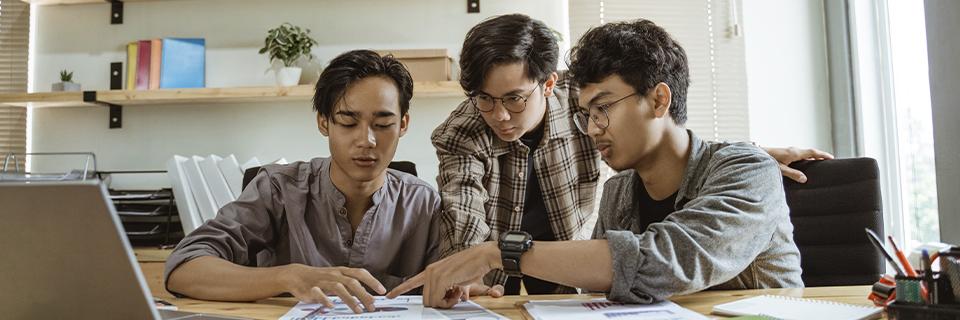 F1 students collaborating on a project, reflecting the ambition and planning involved in transitioning to a Green Card through EB5 investment.