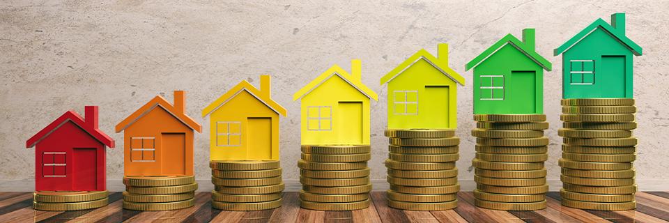 A row of rising coin stacks with colorful house models, representing the growing value and strong market performance of single-family homes in EB5 investments.