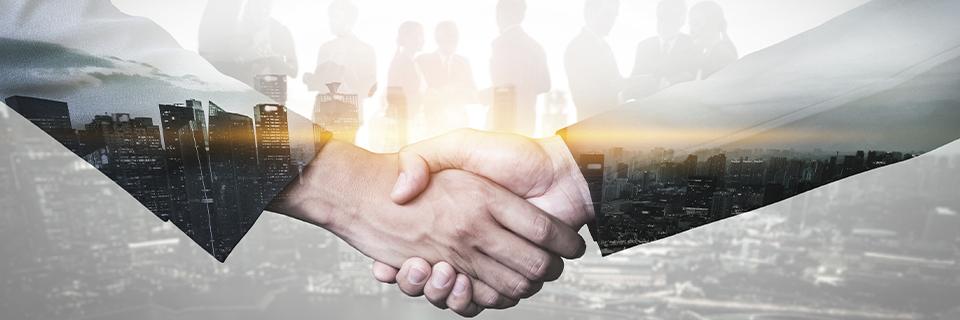 Two business professionals shaking hands with a city skyline overlay, symbolizing EB5 repayment guaranty agreements and investor protections.