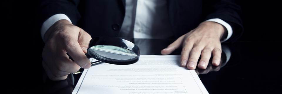 An EB5 investor closely examining legal documents for red flags such as pending RFEs before making an $800,000 investment.